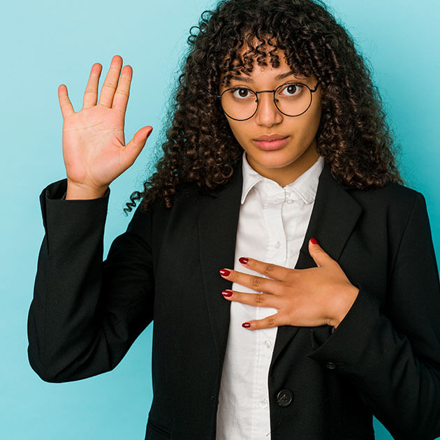 a woman raising her right hand to take an oath