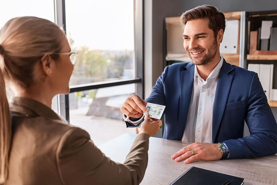 A notary public verifies a client's identification during an appointment