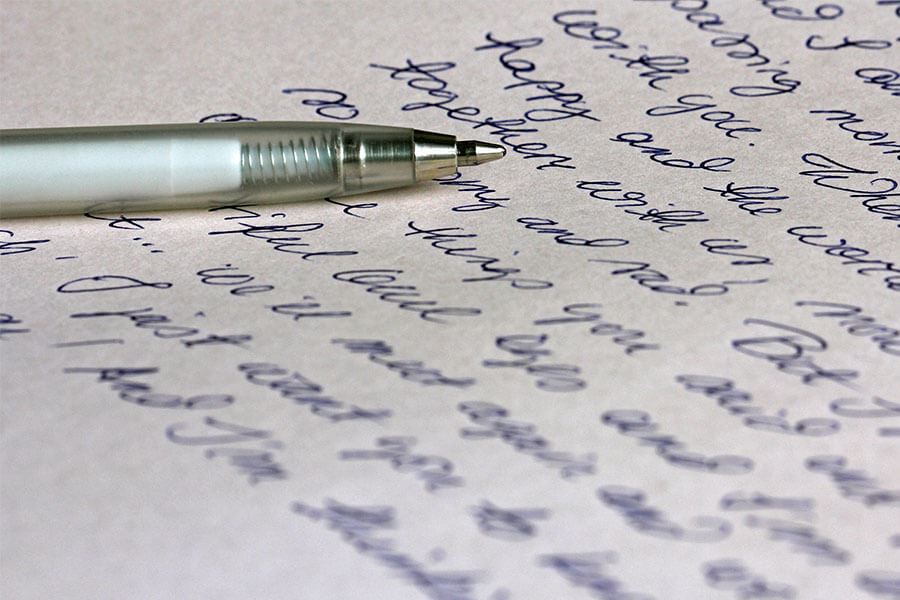 A pen resting on a handwritten note