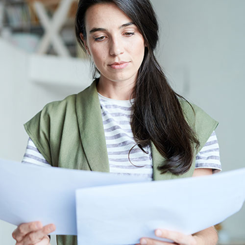 a woman looking at paperwork