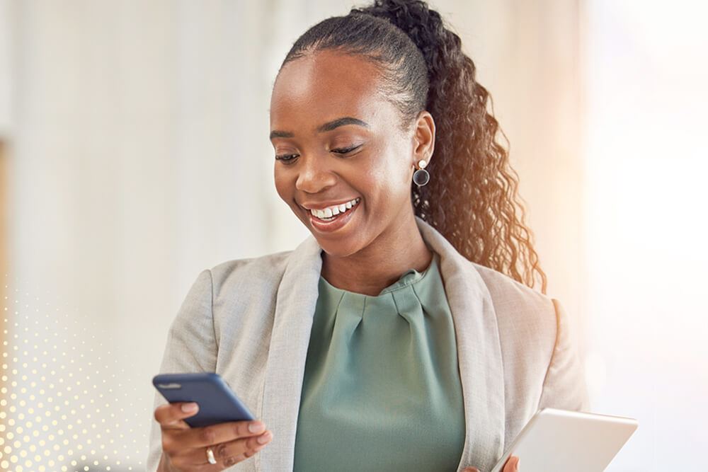 A female Signing Agent looking at her phone