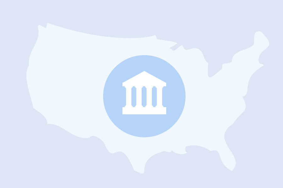 A white silhouette map of the United States with a blue circular icon containing a government building symbol in the center