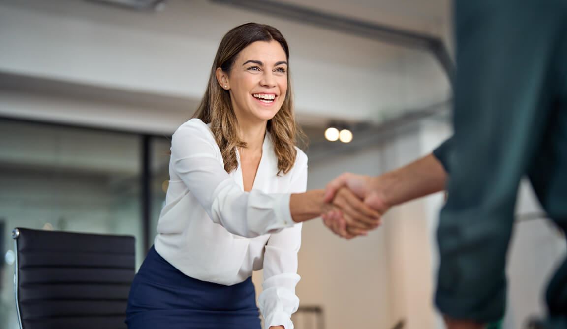 A female Notary shaking hands with a client 